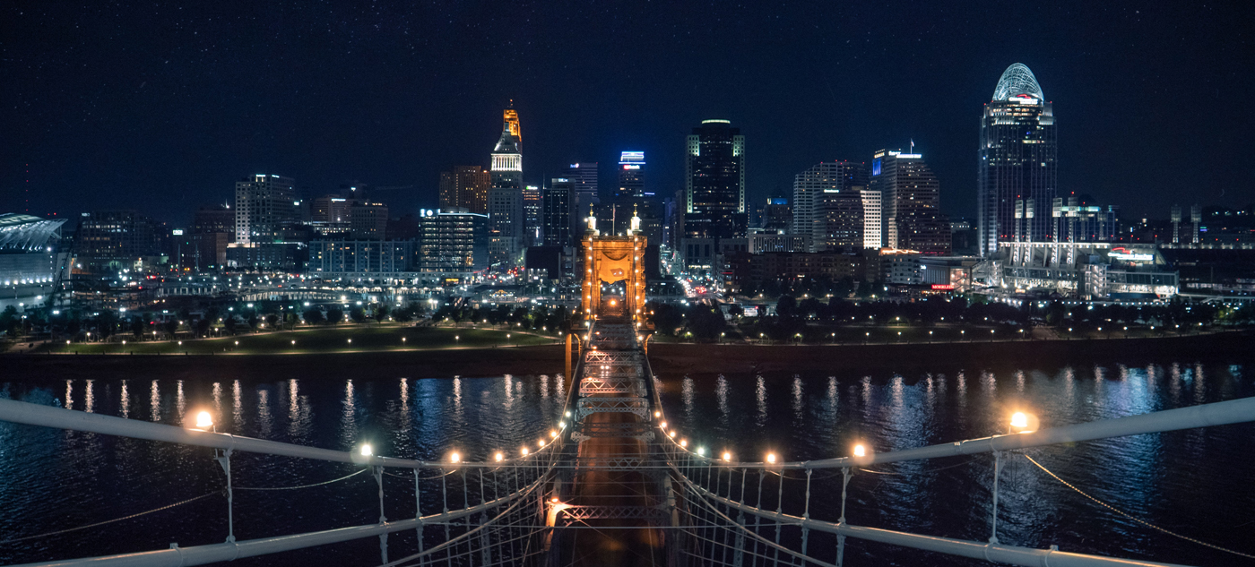 Pretty skyline night view of Cincinnati atop Roebling suspension bridge.