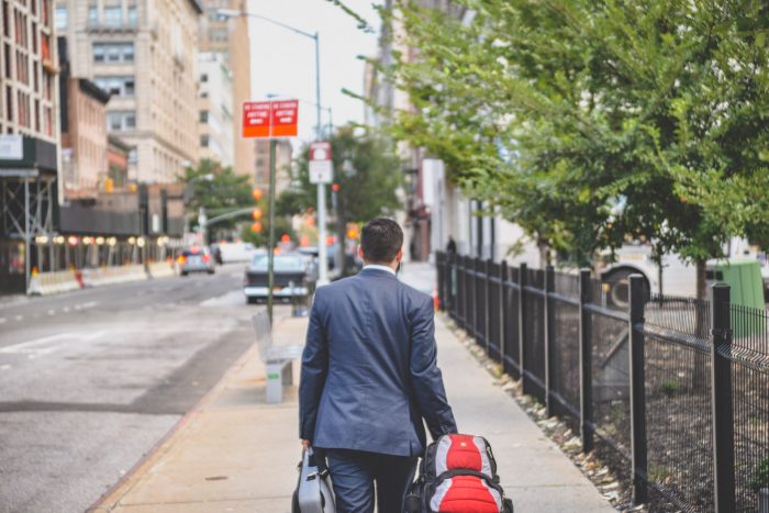 man walks down street after resigning during the great resignation at offices.net