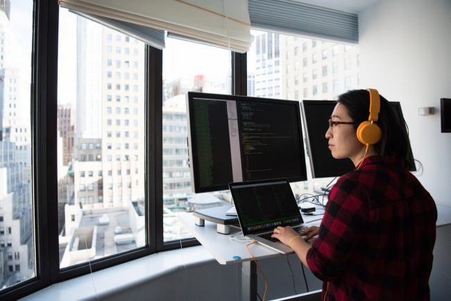 female market analyst looks out window troubled because of uncertainties ahead at offices.net