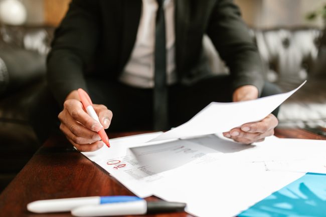 man in suit writes office report at offices.net