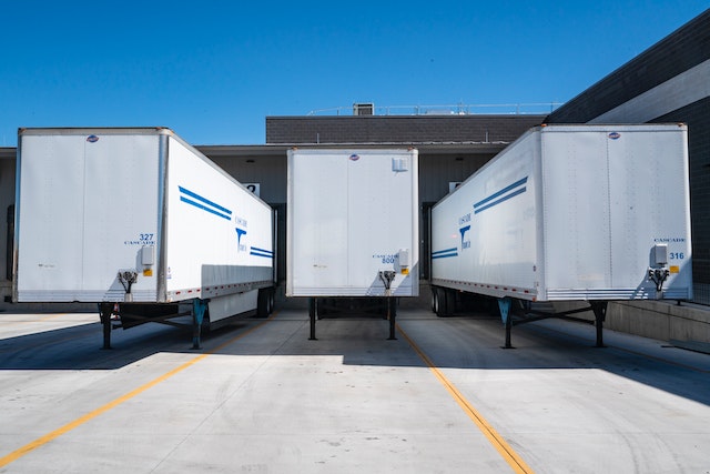 three semi trailers parked outside a depot image at offices.net