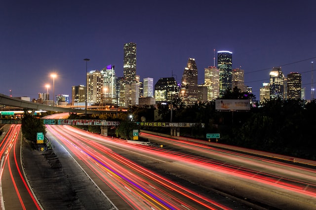 night skyline view from highway of mid 2022 houston commercial real estate market downtown image at offices.net