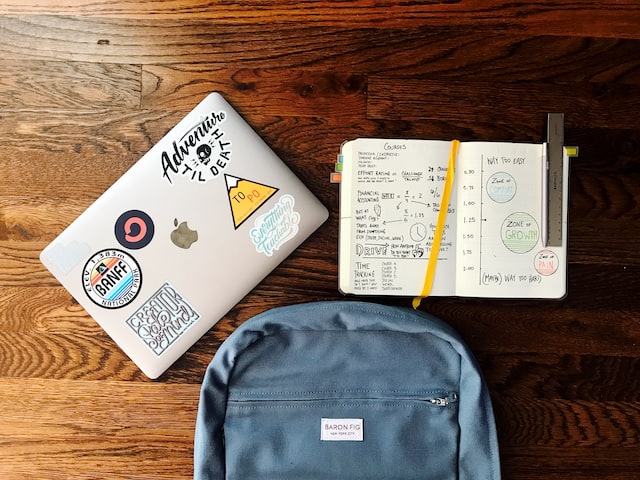 various personal items including laptop, notebook and backpack in a coworking space for students on u.s. college campuses image at offices.net