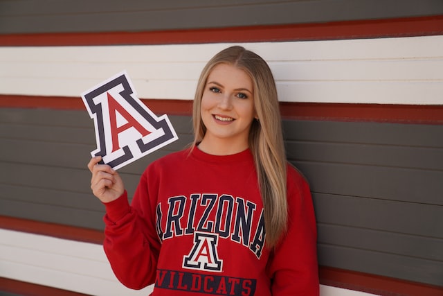 female arizona wildcats cheerleader holding team emblem image at offices.net