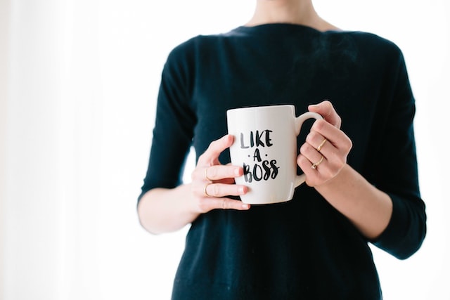 woman holding a like a boss mug image at offices.net