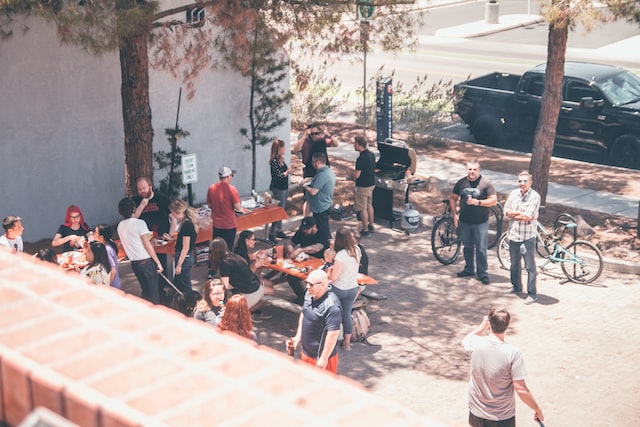 sunny courtyard gathering of colleagues at social function image at offices.net