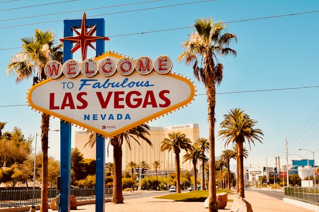 welcome to fabulous las vegas nevada sign in the foreground with palm trees, casinos and resorts in the background image at offices.net