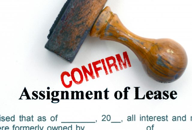 assignment of lease agreement stamped with a red CONFIRM mark