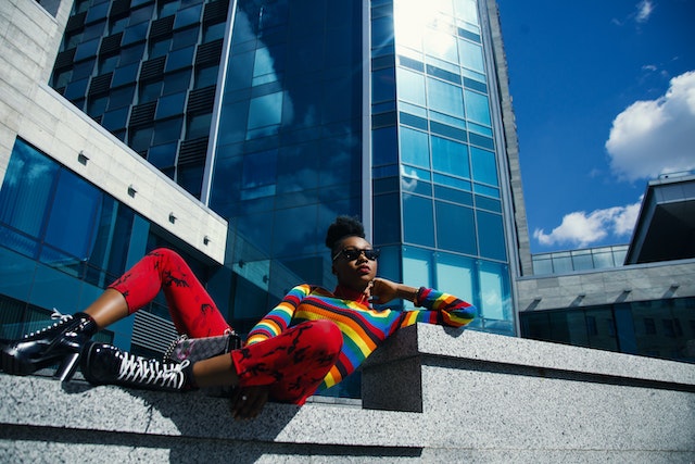 woman leveraging office color psychology reclining outside building in vibrantly colorful outfit image at offices.net
