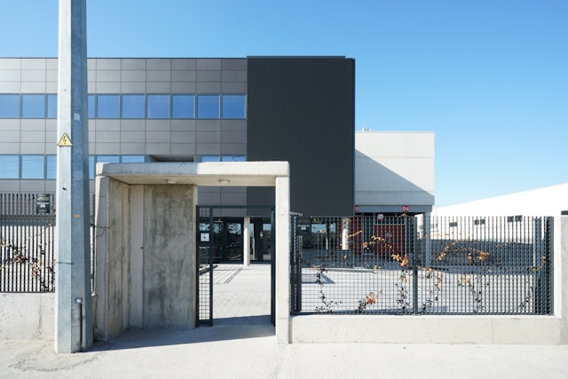 Daytime view from outside the security perimeter gate of a commercial building. Image at Offices.net.